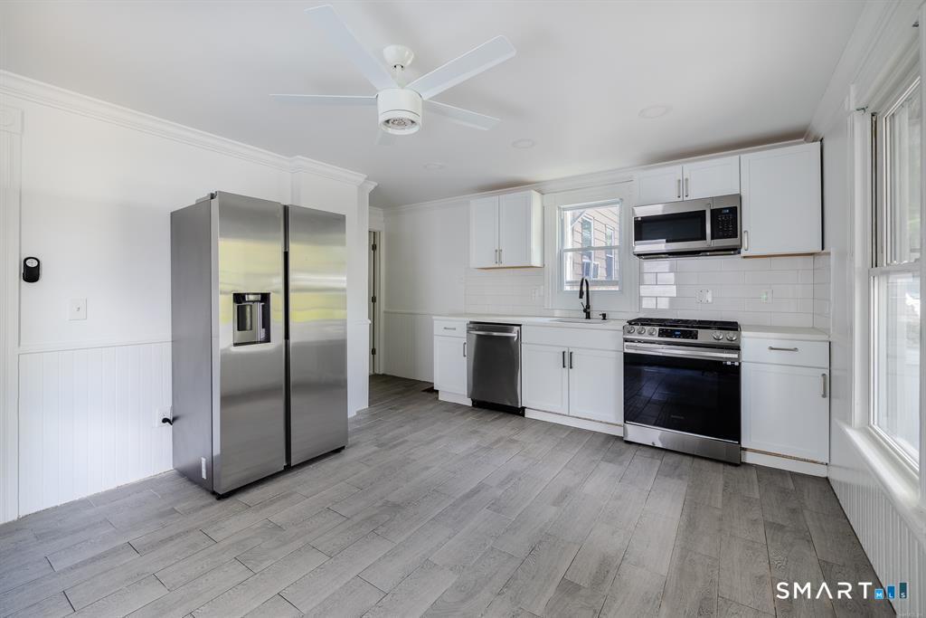 106 Wooster Street Shelton, CT 06484 - Photo 2 of 9 a kitchen with stainless steel appliances a refrigerator sink and microwave