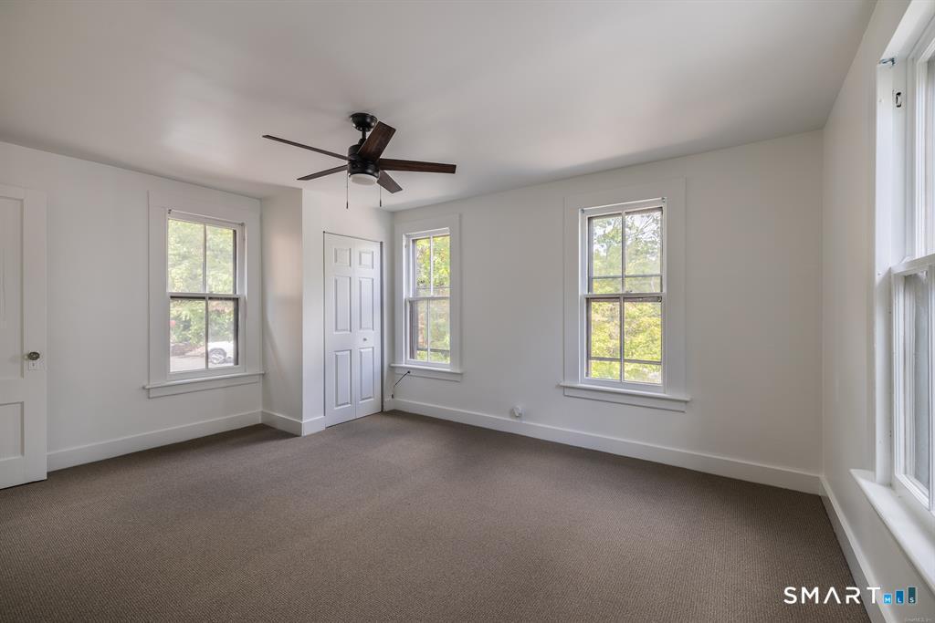 106 Wooster Street Shelton, CT 06484 - Photo 9 of 9 a view of a livingroom with a ceiling fan and window