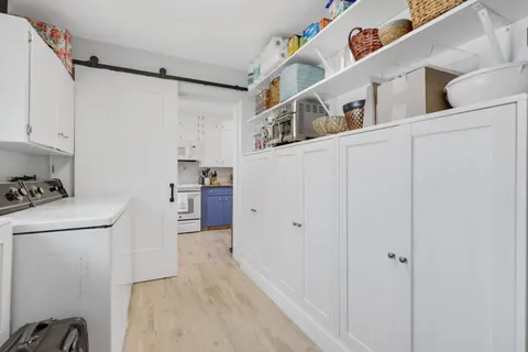a view of kitchen with cabinets and wooden floor