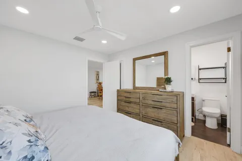 a bedroom with a bed and a large mirror