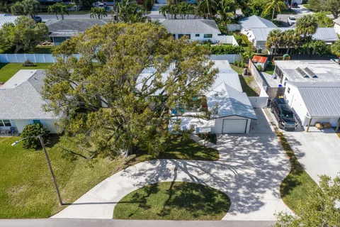 an aerial view of residential houses with outdoor space and street view