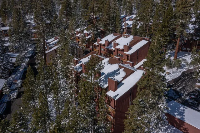 an aerial view of a house with a yard and trees