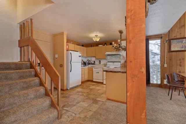 a view of kitchen with furniture and a refrigerator