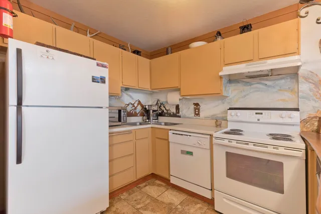 a kitchen with a stove a refrigerator and a sink