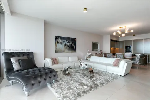 a living room with furniture and large window