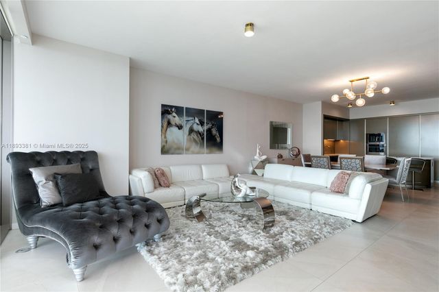 a living room with furniture and large window