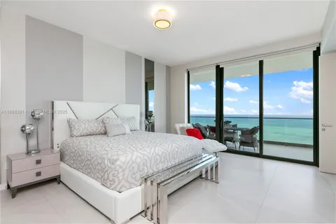 a spacious bedroom with a bed and a couch