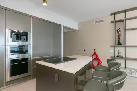 a kitchen with a table and chairs