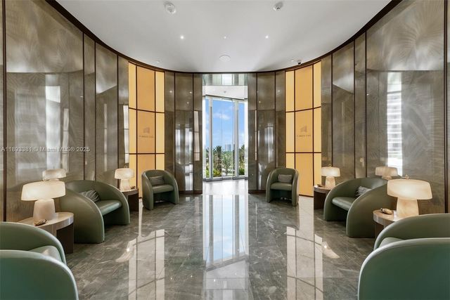 a room with lots of tables a large window and chairs