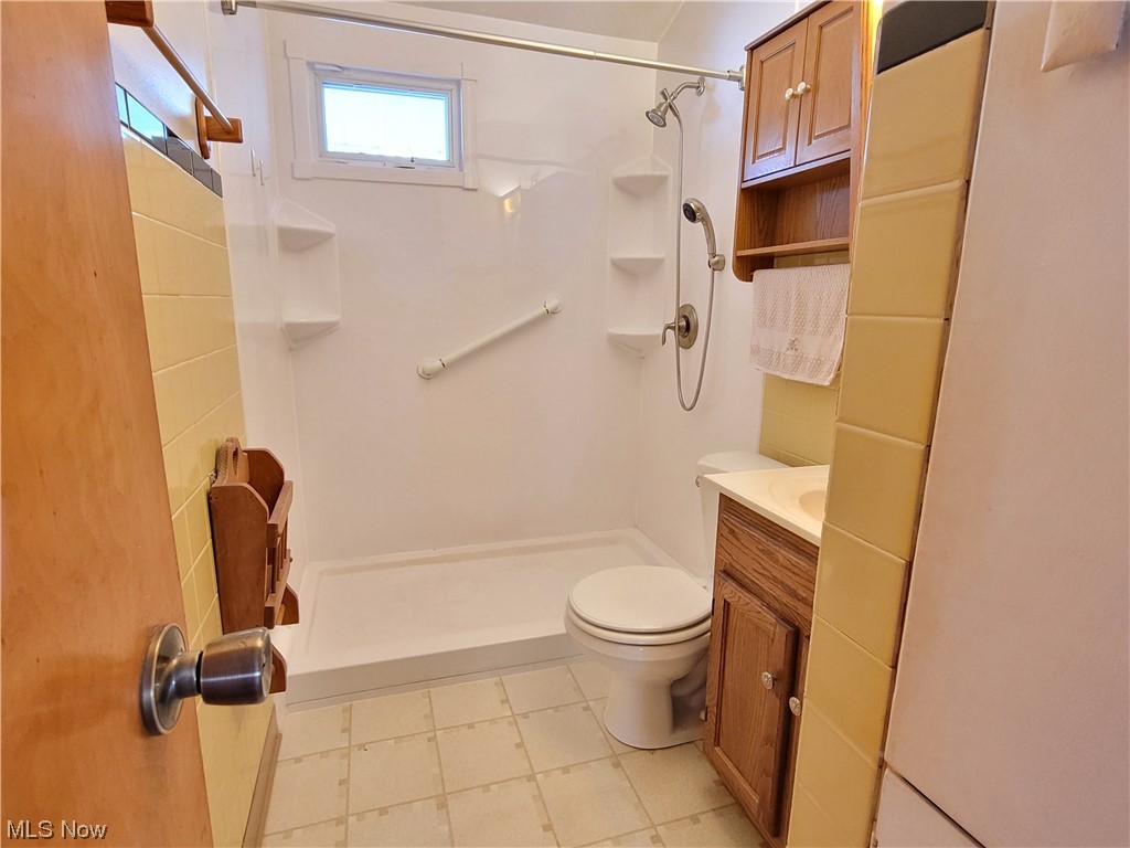 357 Abbe Road North Elyria, OH 44035 - Photo 11 of 25 Bathroom featuring walk in shower, toilet, and vanity