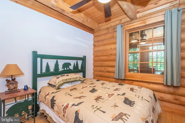 a bedroom with two beds and a large window