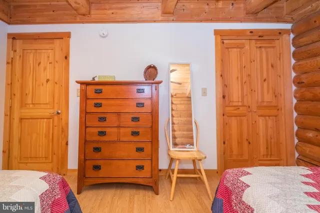 a bedroom with two beds and two windows