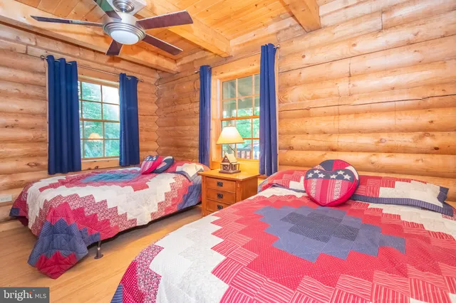 a living room with furniture and large windows