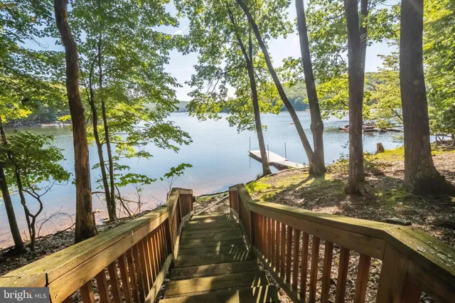 swimming pool view with a lake view