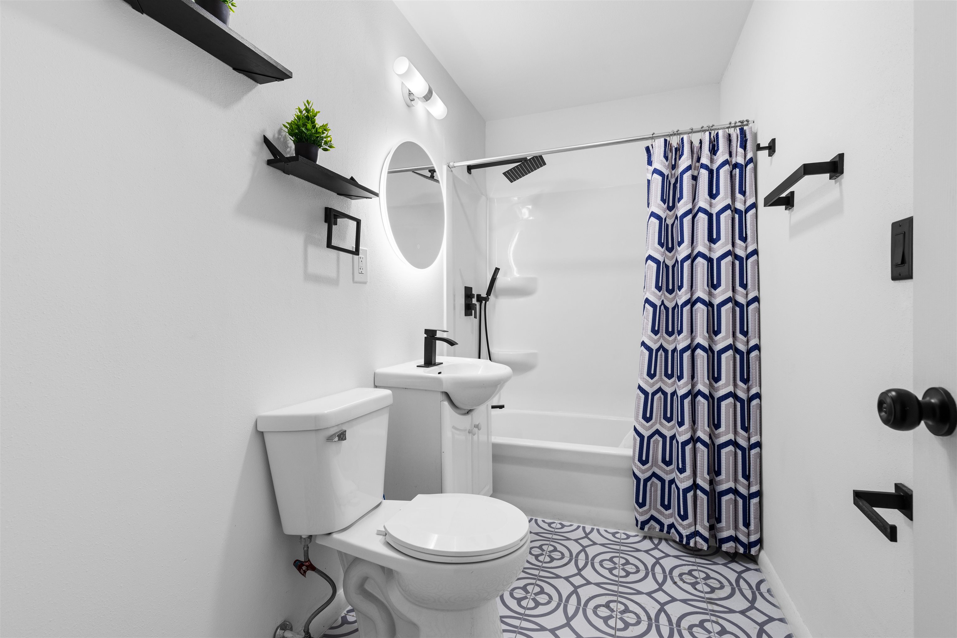 4012 Highcrest Road Rockford, IL 61107 - Photo 18 of 30 a white toilet sitting next to a shower curtain