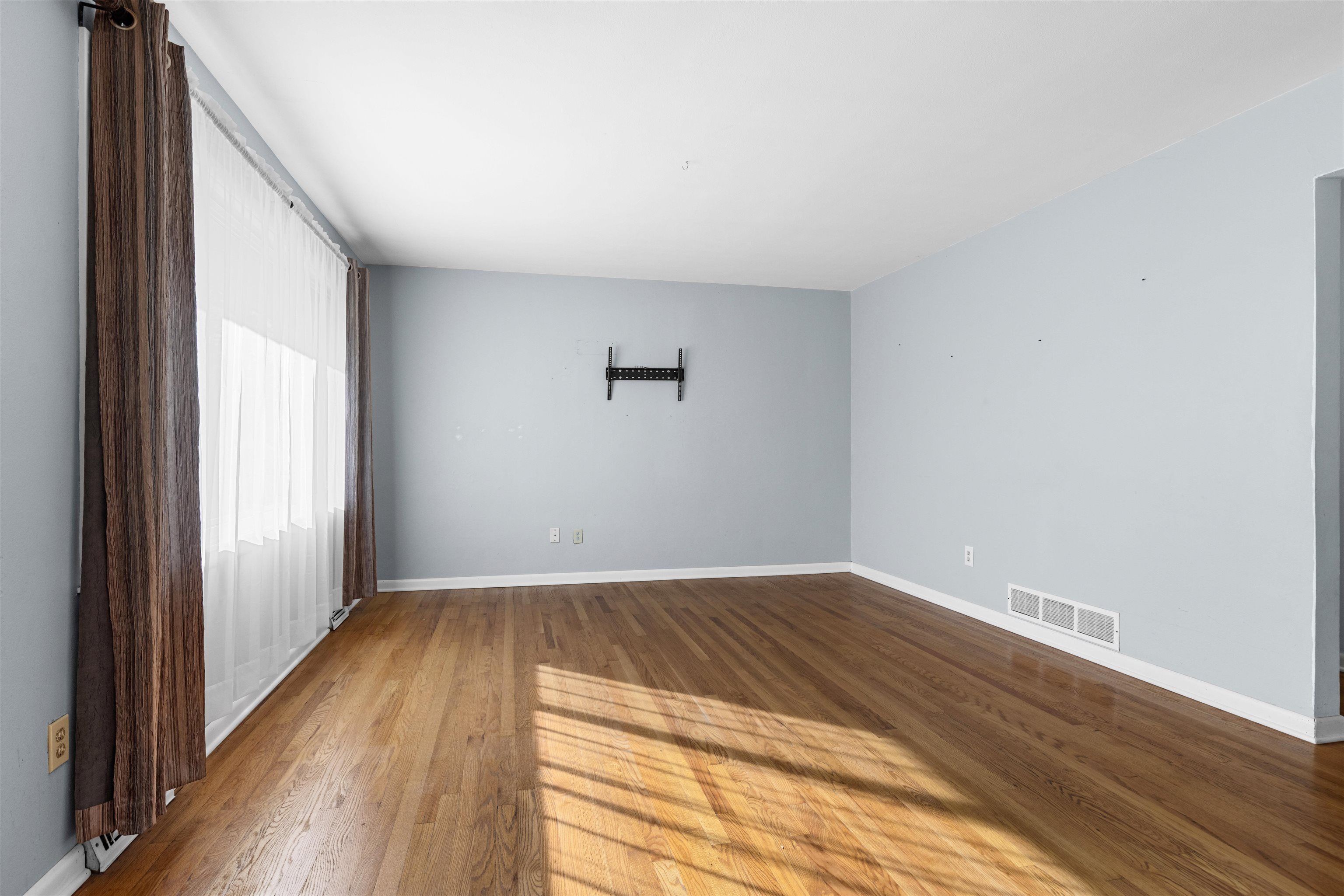4012 Highcrest Road Rockford, IL 61107 - Photo 3 of 30 a view of an empty room with wooden floor and a window