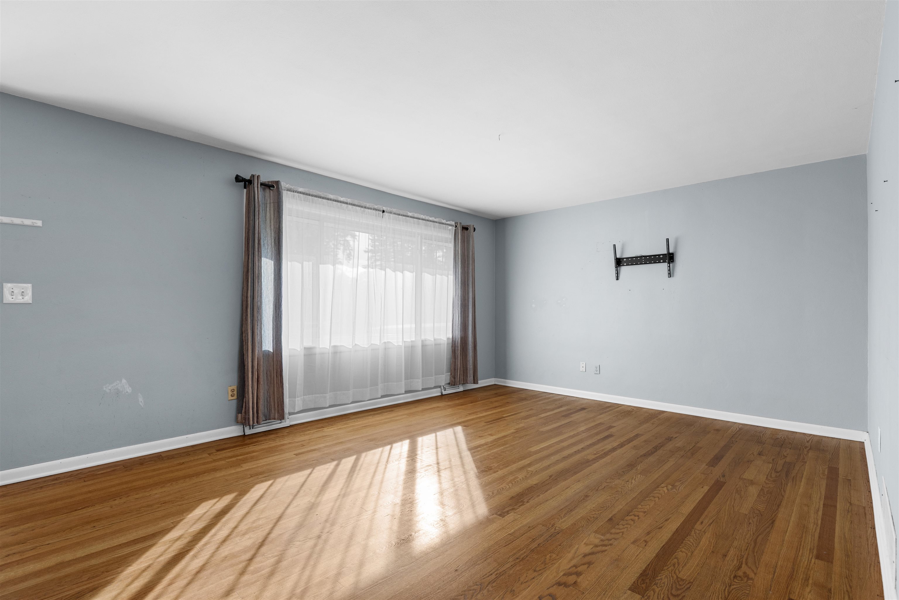 4012 Highcrest Road Rockford, IL 61107 - Photo 4 of 30 a view of an empty room with wooden floor and a window