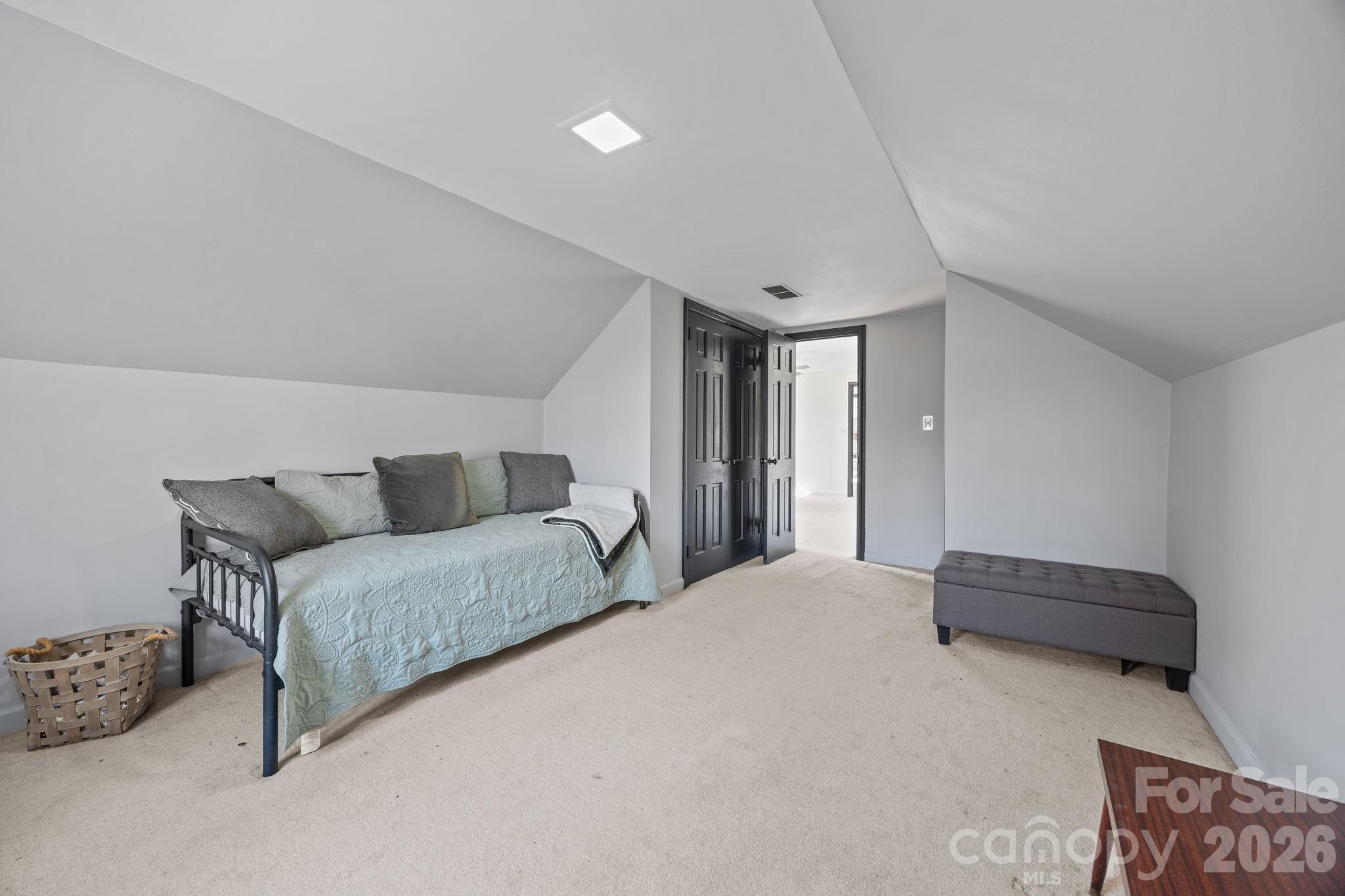 1352 City Lake Road Lexington, NC 27295 - Photo 21 of 36 a spacious bedroom with a bed and a couch