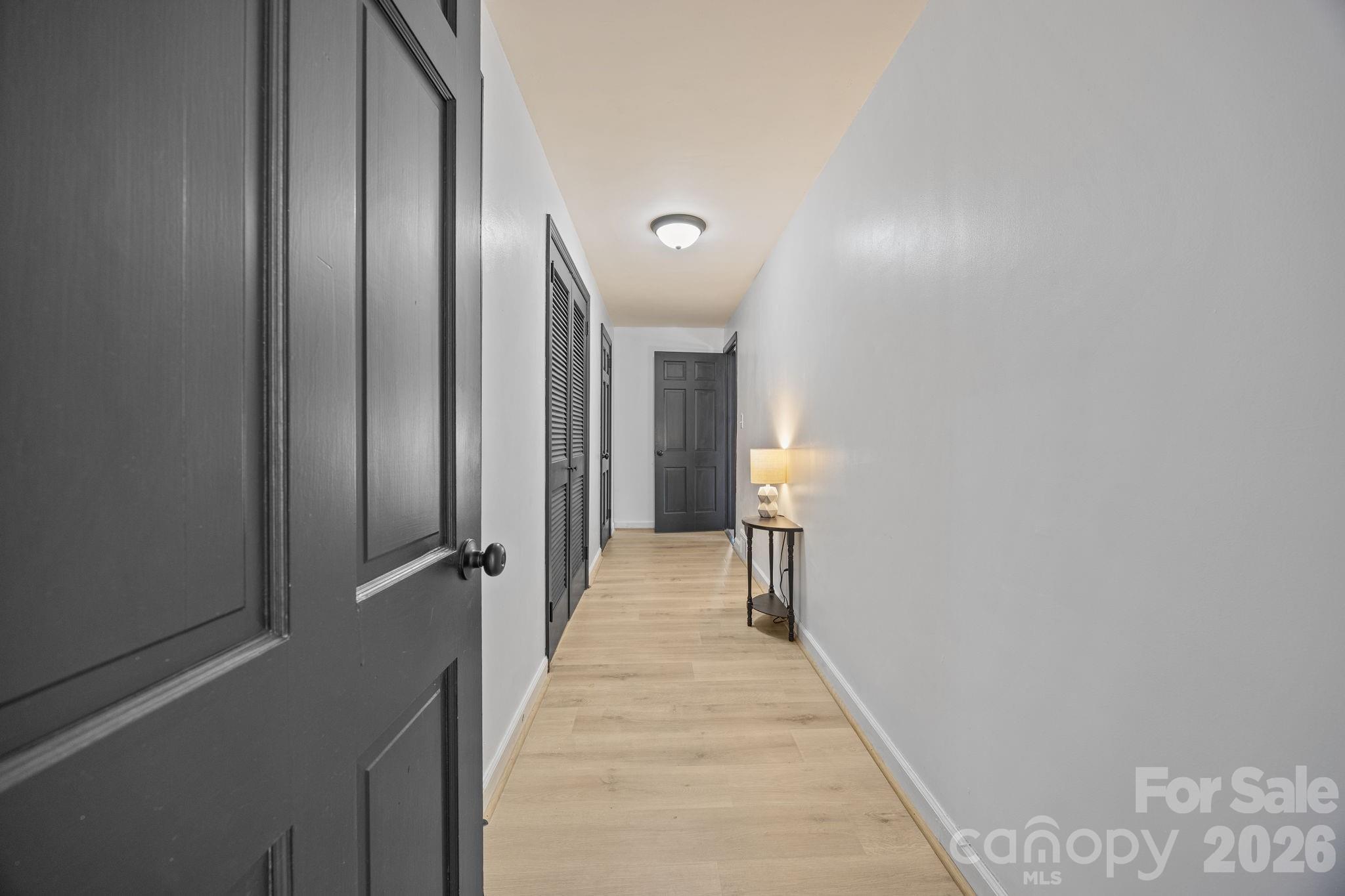 1352 City Lake Road Lexington, NC 27295 - Photo 25 of 36 a view of a hallway with wooden floor and staircase
