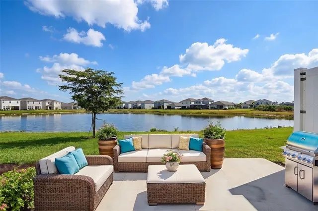 a view of a lake with couches and city view