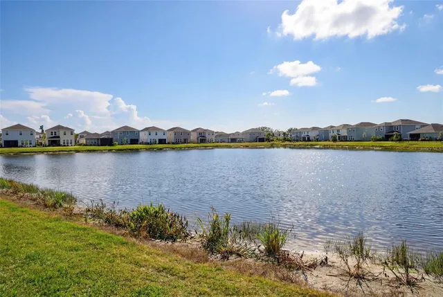 an aerial view of residential building and lake