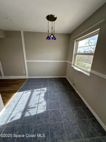 a room with a window and a rug