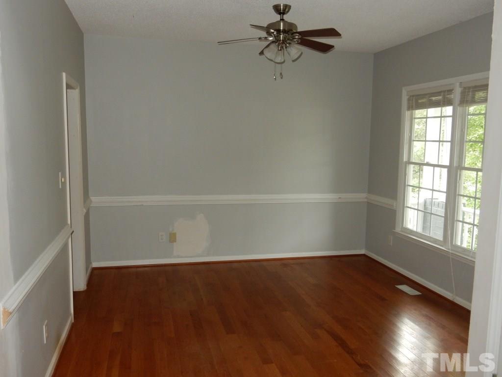 5313 Denmead Way Raleigh, NC 27613 - Photo 3 of 18 wooden floor in an empty room with a window