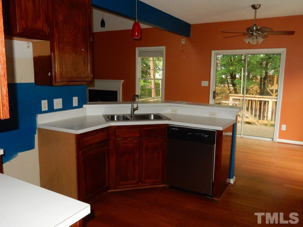 5313 Denmead Way Raleigh, NC 27613 - Photo 4 of 18 a kitchen with a sink cabinets and wooden floor