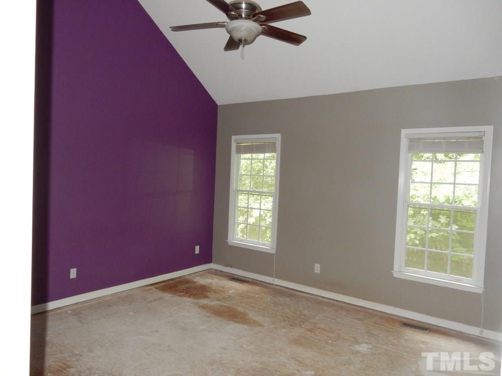 5313 Denmead Way Raleigh, NC 27613 - Photo 7 of 18 an empty room with a window and a fan