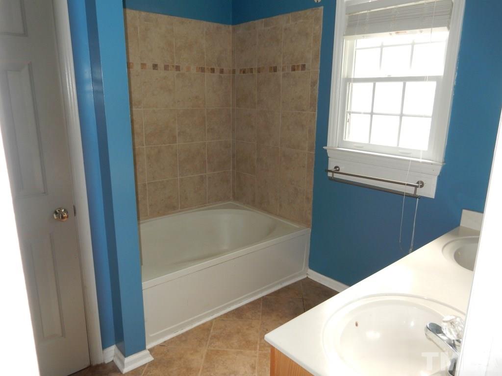 5313 Denmead Way Raleigh, NC 27613 - Photo 8 of 18 a bathroom with a bathtub and a sink