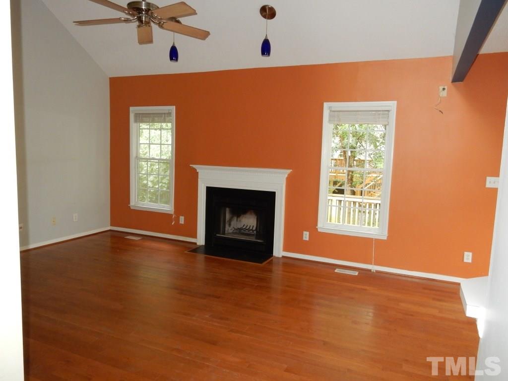 5313 Denmead Way Raleigh, NC 27613 - Photo 9 of 18 a view of an empty room with a window and fireplace