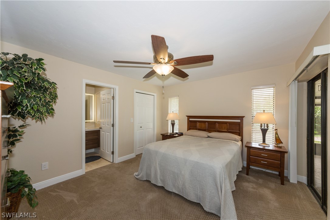 13258 Heather Ridge Loop Fort Myers, FL 33966 - Photo 14 of 22 a bedroom with a large bed and a chandelier