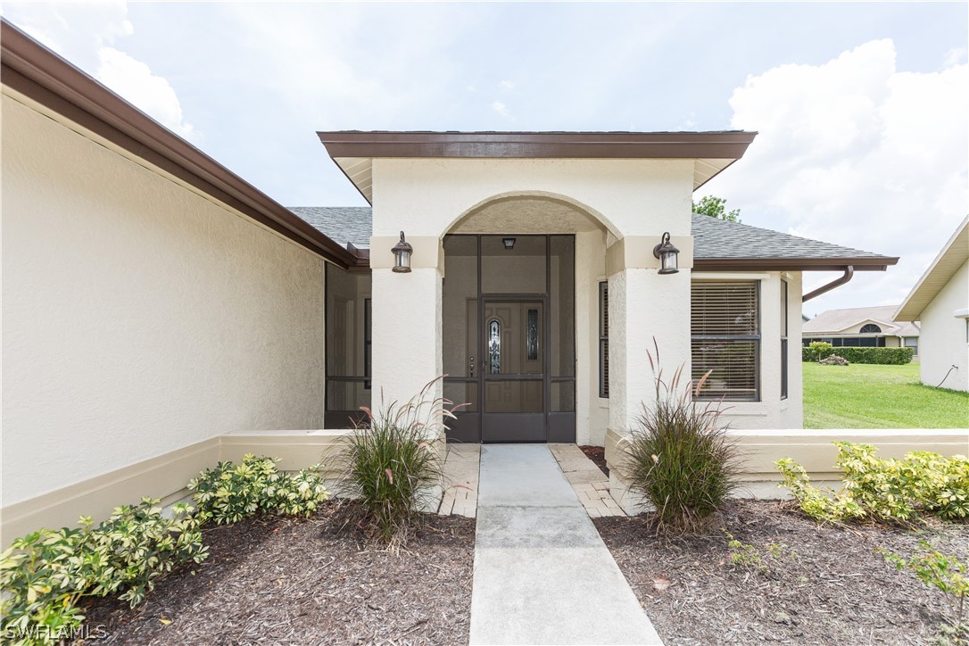 13258 Heather Ridge Loop Fort Myers, FL 33966 - Photo 2 of 22 a front view of a house with garden