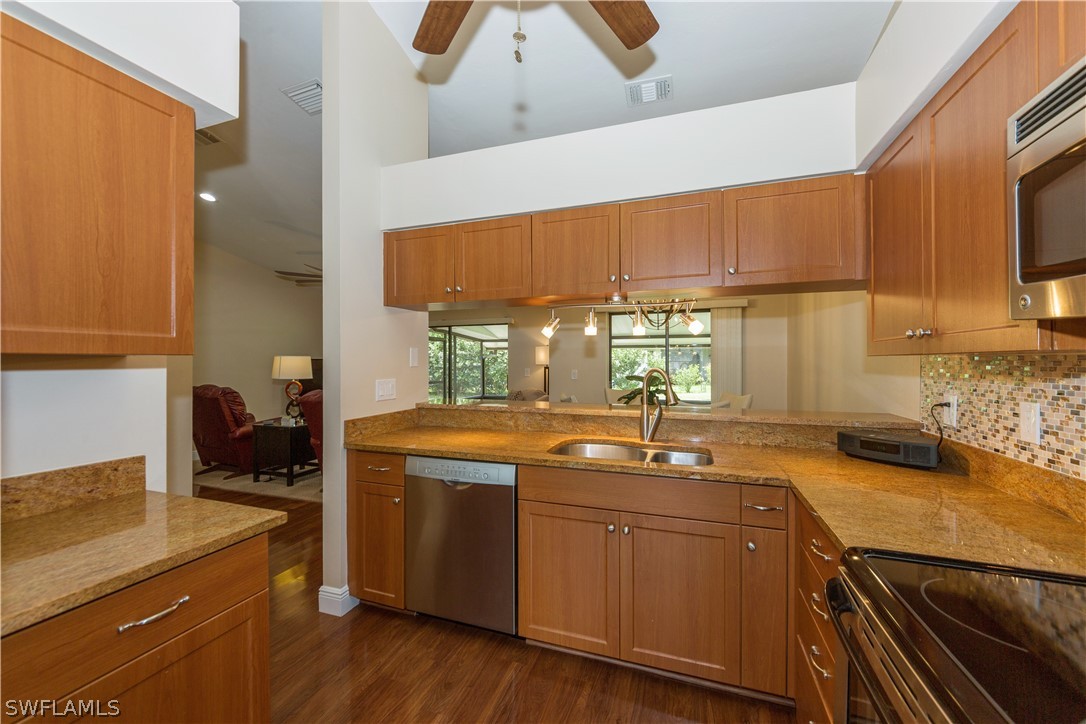13258 Heather Ridge Loop Fort Myers, FL 33966 - Photo 4 of 22 a kitchen with a sink a stove and cabinets