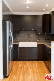 a kitchen with a sink a refrigerator and a microwave