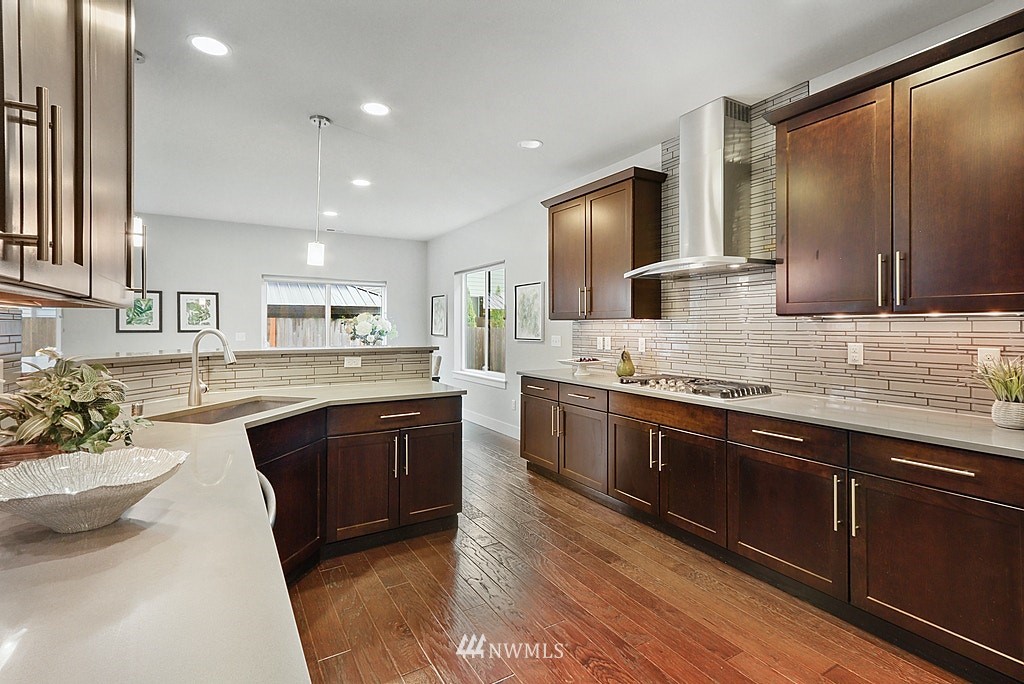 16808 1st Avenue West Bothell, WA 98012 - Photo 12 of 29 a large kitchen with stainless steel appliances kitchen island granite countertop a sink dishwasher stove and cabinets
