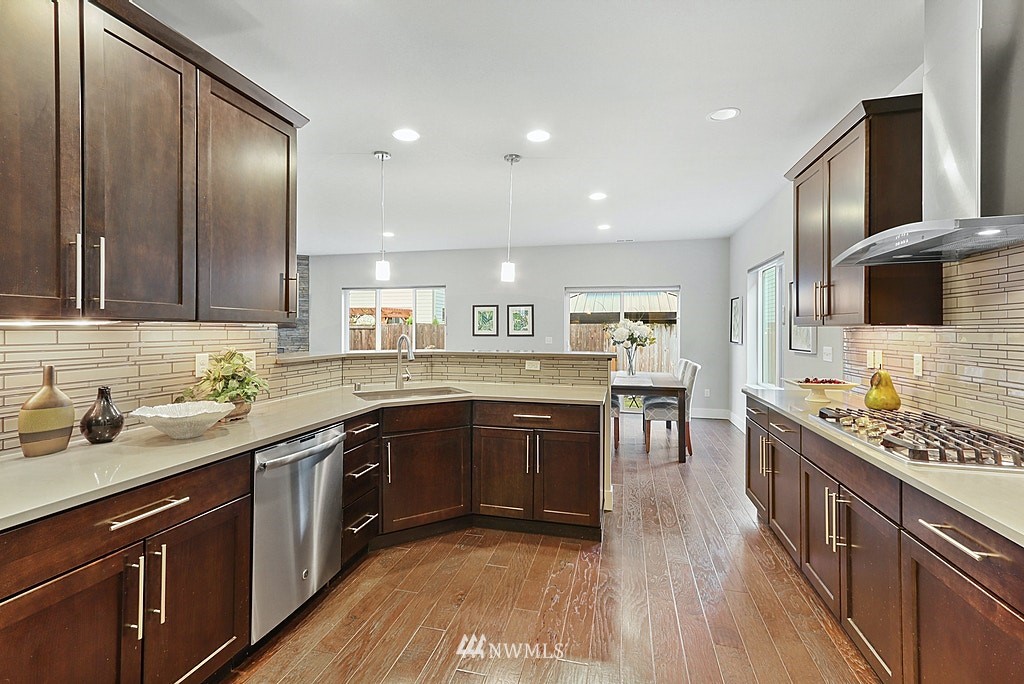 16808 1st Avenue West Bothell, WA 98012 - Photo 13 of 29 a kitchen with stainless steel appliances granite countertop sink stove top oven and cabinets