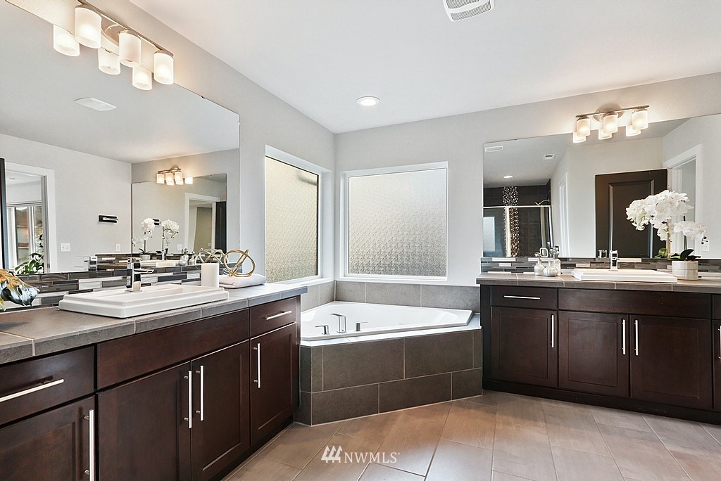 16808 1st Avenue West Bothell, WA 98012 - Photo 21 of 29 a large bathroom with a double vanity sink mirror and bathtub