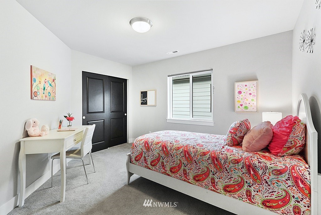 16808 1st Avenue West Bothell, WA 98012 - Photo 24 of 29 a bedroom with a bed and a table in it