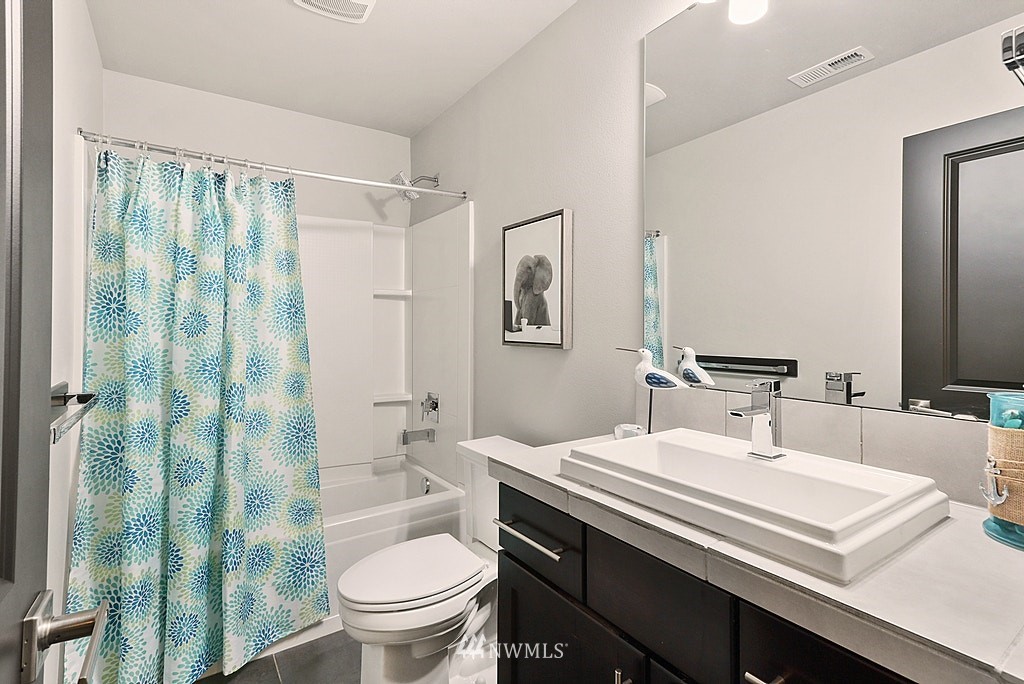 16808 1st Avenue West Bothell, WA 98012 - Photo 26 of 29 a bathroom with a sink a toilet and shower