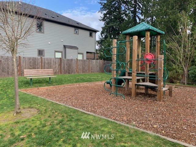 16808 1st Avenue West Bothell, WA 98012 - Photo 29 of 29 a view of a backyard with table and chairs under an umbrella