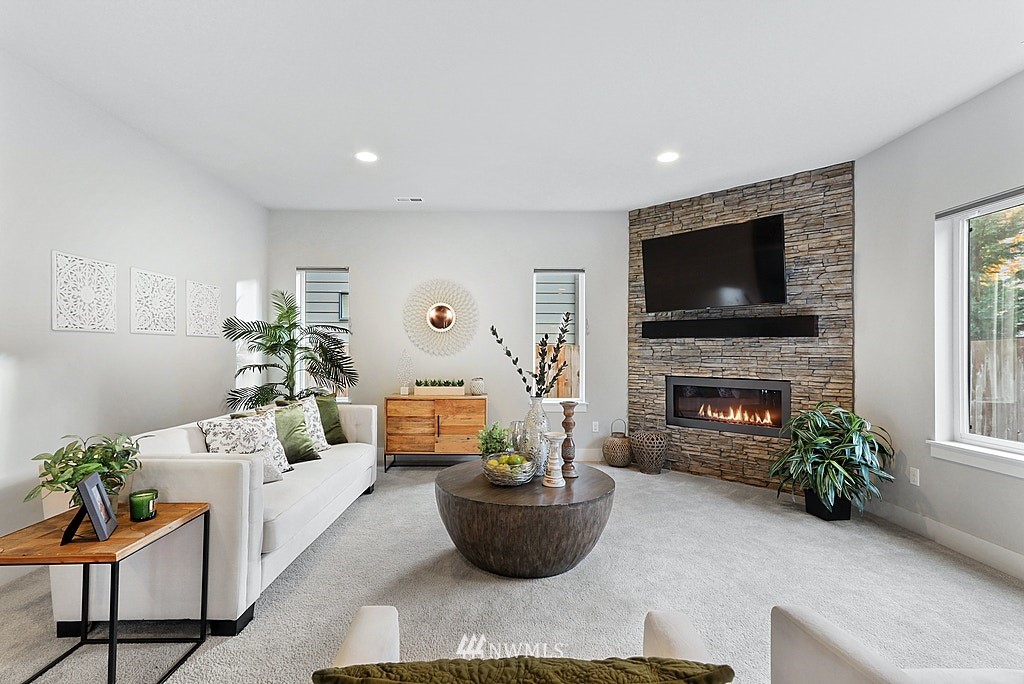 16808 1st Avenue West Bothell, WA 98012 - Photo 6 of 29 a living room with furniture a fireplace and a potted plant