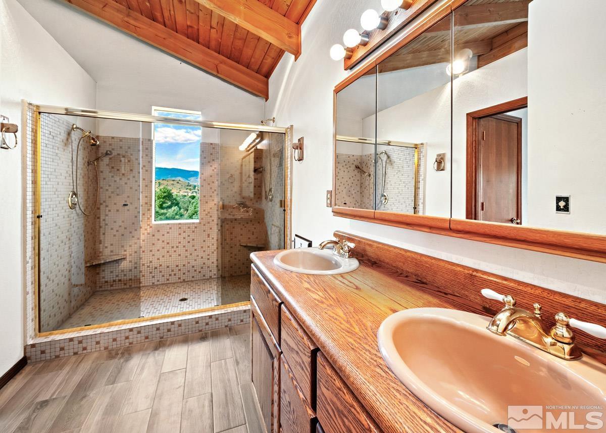 15866 Toll Road Reno, NV 89521 - Photo 12 of 29 a bathroom with a sink double vanity and a shower