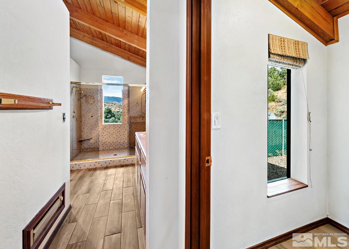 15866 Toll Road Reno, NV 89521 - Photo 14 of 29 a view of a hallway with wooden floor and a living room