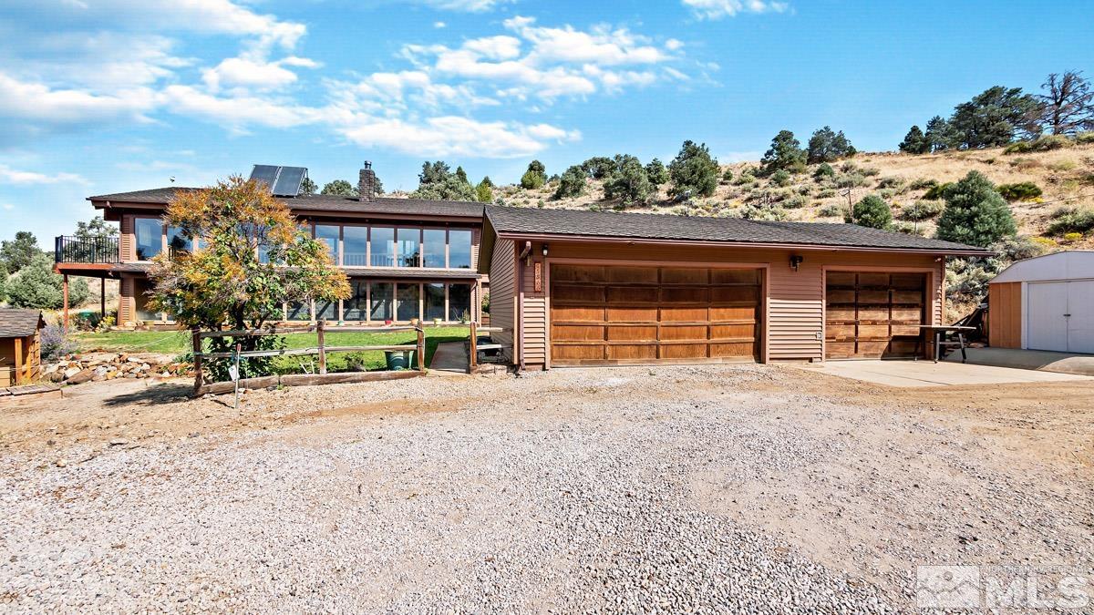 15866 Toll Road Reno, NV 89521 - Photo 25 of 29 a front view of a house with a yard and garage