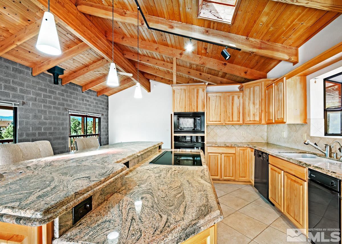 15866 Toll Road Reno, NV 89521 - Photo 3 of 29 a kitchen with a stove a sink and a refrigerator