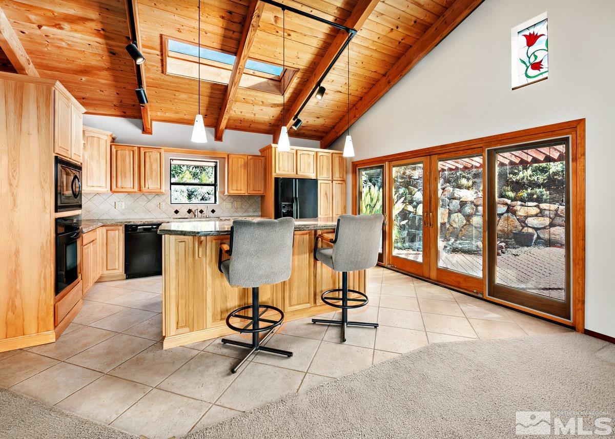 15866 Toll Road Reno, NV 89521 - Photo 4 of 29 a view of a dining room with furniture a chandelier and wooden floor