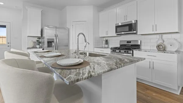 a kitchen with stainless steel appliances granite countertop a sink a microwave and cabinets