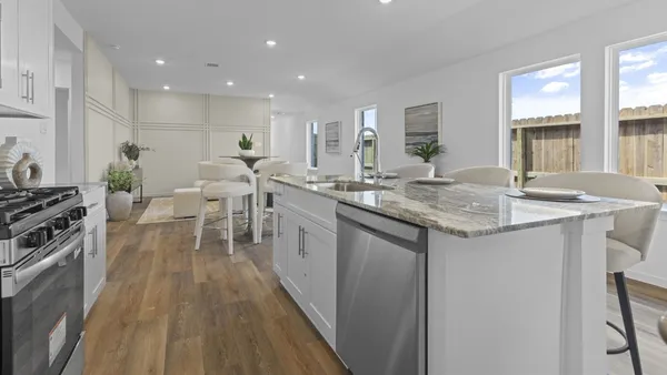 a kitchen with a sink stove and wooden cabinets