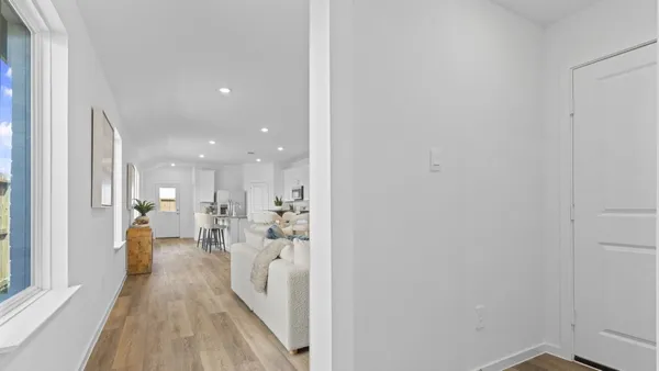 a view of a living room and a wooden floor
